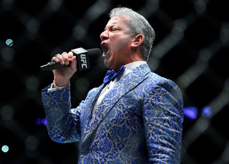 Bruce Buffer in a blue suit poses for a picture..